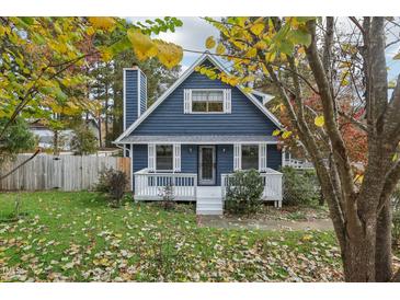 Charming blue two-story home with a cozy front porch and a well-manicured, inviting lawn at 3746 Guess Rd, Durham, NC 27705
