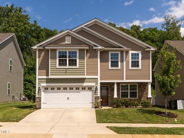Charming two-story home with a two-car garage and manicured lawn, perfect for curb appeal at 516 Spaulding St, Burlington, NC 27215