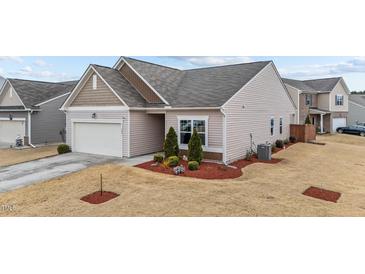 Inviting single-Gathering home with a manicured front yard and attached two-car garage at 629 Kenyon Spring Dr, Zebulon, NC 27597