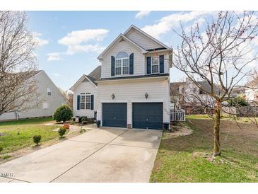 Two-story home features a two-car garage, blue shutters, and a well-manicured lawn at 917 Widewaters Pkwy, Knightdale, NC 27545
