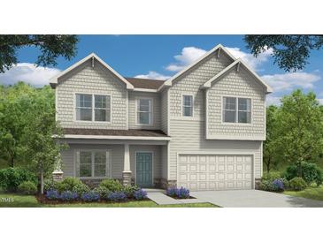 Charming two-story home with white siding, stone accents, lush landscaping, and an attached two-car garage at 190 Cribbs Ln, Middlesex, NC 27557