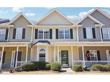 Charming townhouse featuring a cozy front porch, neat landscaping, and a welcoming entrance at 3809 Volkswalk Pl, Raleigh, NC 27610