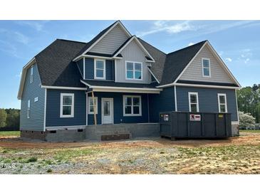 New home with blue siding, white trim, and a dark roof, showcasing modern design and construction at 70 Prency Ln, Middlesex, NC 27557