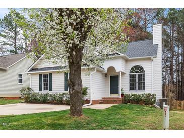 Charming single-story home featuring a blossoming tree, landscaped yard, and inviting entrance at 936 Amersham Ln, Wake Forest, NC 27587