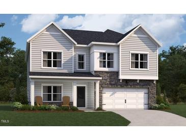 Charming two-story home with stone accents, a two-car garage, and a well-manicured lawn at 108 N Stonemill Trl # Homesite 254, Wilson's Mills, NC 27520