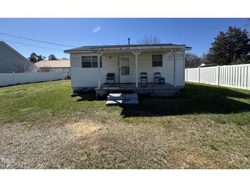 Cozy home with a quaint front porch and seating, perfect for relaxing outdoors at 113 Smith St, Four Oaks, NC 27524