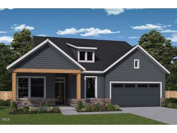 Charming one-story home with stone accents, wood porch supports, and a lovely landscaped front yard at 122 Wabash St, Pittsboro, NC 27312