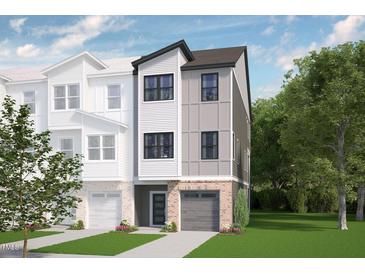 Charming townhome boasts a modern facade with a brick base and a well-manicured lawn at 173 Shakespeare Dr, Homesite 46, Morrisville, NC 27560