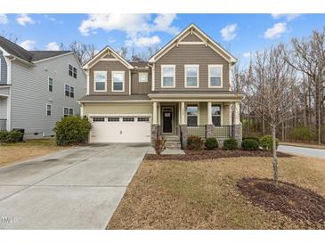 Charming two-story home with a welcoming front porch and attached two car garage at 1800 Bodwin Ln, Apex, NC 27502