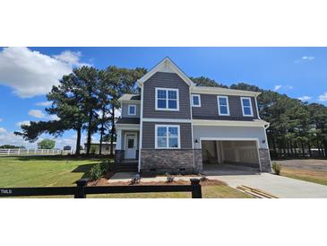 Beautiful two-story home with stone accents and a spacious two-car garage at 33 White Azalea Way, Homesite 80, Benson, NC 27504