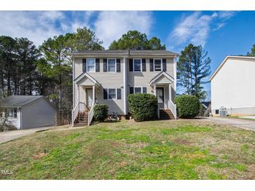 Neutral siding adorns this multi-Gathering unit with black shutters and tidy landscaping in a well-maintained yard at 6225 Tributary Dr, Raleigh, NC 27609
