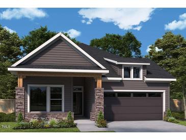 Charming single-Gathering home with stone accents, a covered entry, and a two-car garage at 67 Wabash St, Pittsboro, NC 27312