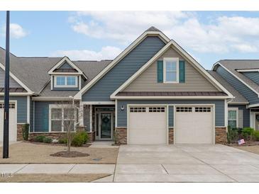 Charming two-car garage home with stone accents, neutral colors, and inviting curb appeal at 74 Powderhorn Pt, Garner, NC 27529