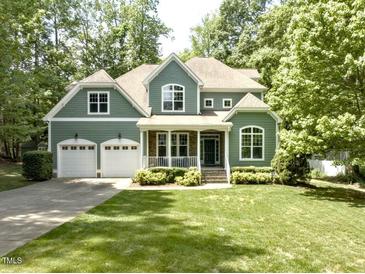 Charming two-story home featuring a well-manicured lawn, attached two-car garage, and a welcoming front porch at 1425 Princess Anne Rd, Cary, NC 27607