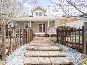 Charming home featuring a welcoming front porch with brick stairs and a beautifully landscaped front yard at 1426 N Roxboro St, Durham, NC 27701
