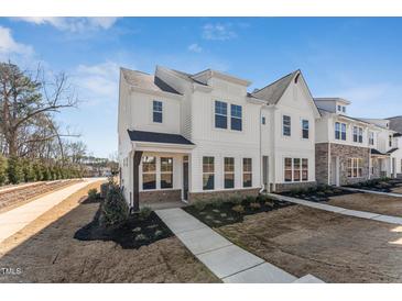Charming two-story home featuring a covered porch and beautifully landscaped front yard at 1432 Cooper St, Sanford, NC 27330