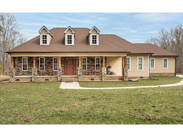 Inviting single-story home with a charming front porch and rocking chairs at 195 Falcon Ln, Rougemont, NC 27572