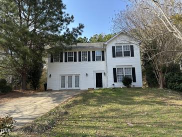 Charming two-story home with a well-manicured lawn and a classic black door at 316 Arbor Greene Dr, Garner, NC 27529