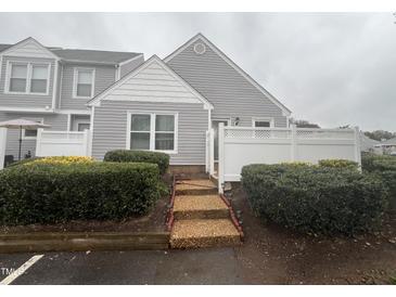 Charming townhome with manicured landscaping, neutral siding, and a welcoming entryway at 5054 Avenida Del Sol Dr, Raleigh, NC 27616