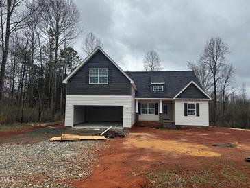 Two-story home with dark gray accent siding and an attached two-car garage on a cloudy day at 5344 Salem Woods Dr # 20, Graham, NC 27253