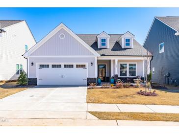 Charming single-Gathering home with a two-car garage and well-manicured front yard at 74 Silver Moon Ln, Clayton, NC 27527