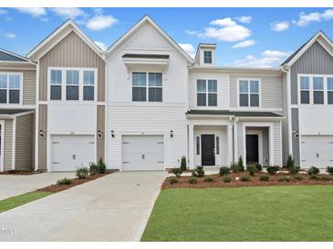 Charming townhome featuring a one-car garage, well-kept lawn, and modern architectural design at 96 Ripple Way # 316, Clayton, NC 27520