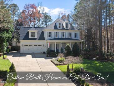 Charming two-story home with a well-manicured front yard and attached two car garage at 1006 Henny Pl, Raleigh, NC 27614