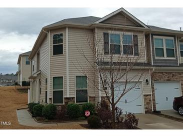 Beautiful townhome featuring traditional architecture, private driveway, and well-maintained landscaping at 1022 Azimuth Dr, Durham, NC 27713