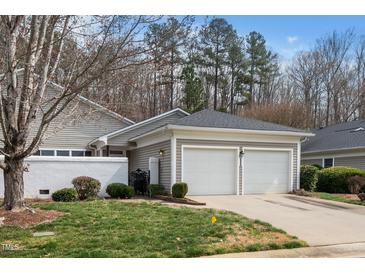 Charming home featuring an attached two-car garage and mature landscaping at 1331 Langdon Pl, Pittsboro, NC 27312