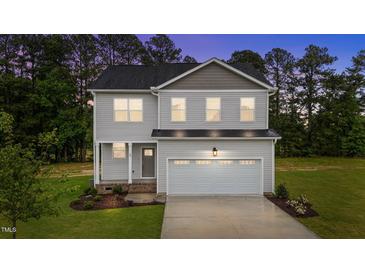 Charming two-story home with landscaped yard and an attached two-car garage at 20 Diamond Creek Dr, Zebulon, NC 27597