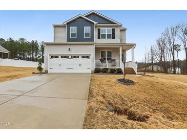 Charming two-story home with a welcoming front porch and a well-manicured lawn at 440 Pierce Landing Dr, Garner, NC 27529