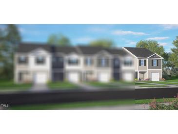 New two-story townhome with attached garage, grey horizontal siding and black shutters at 50 Sweet Meadow Rd, Angier, NC 27501