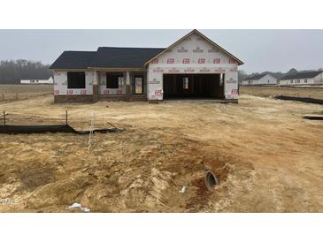New construction home featuring a brick foundation and an attached garage at 59 Pagani Dr, Kenly, NC 27542