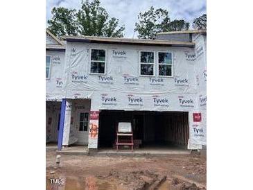 Unfinished townhouse shows the framing and structure, pre-drywall, with the garage visible at 6964 Doddridge Ln # 13, Cary, NC 27519