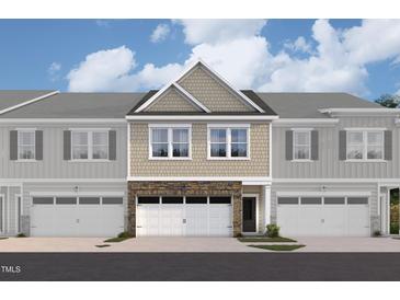 New construction townhome with stone accents, neutral siding, and attached garages under a cloudy, bright blue sky at 6966 Doddridge Ln # 12, Cary, NC 27519