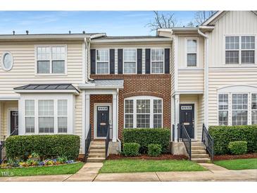 Charming townhomes featuring well-maintained lawns, brick facades, and updated exterior paint colors at 7753 Winners Edge St, Raleigh, NC 27617