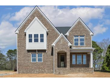 Newly built two-story brick home with gabled roofline and covered entryway at 9000 Penny Rd, Raleigh, NC 27606