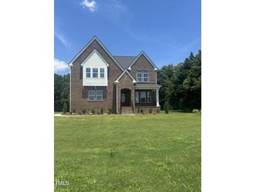 Beautiful two-story brick home featuring large front lawn and classic architectural details in a desirable neighborhood at 9000 Penny Rd, Raleigh, NC 27606