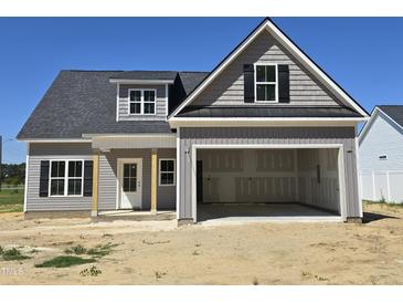 New two-story home with gray siding, open garage and covered front porch at 1039 N Lincoln St, Benson, NC 27504
