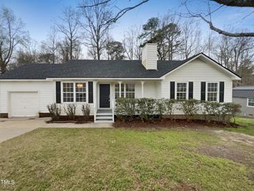 Charming single-story home with a well-manicured lawn and inviting curb appeal at 1213 Cotten Farm Dr, Fuquay Varina, NC 27526