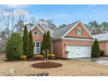 Charming single-story brick home with a two-car garage and manicured landscaping at 201 Hales Wood Rd, Chapel Hill, NC 27517