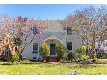 Charming two-story home with a brick walkway and flowering trees in a well-maintained front yard at 1010 Rosehill Ave, Durham, NC 27705