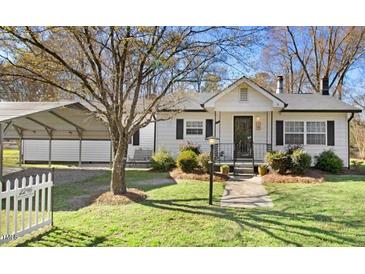Charming home with black shutters, a covered carport, and a well-maintained lawn at 2246 Arrowhead Rd, Dunn, NC 28334