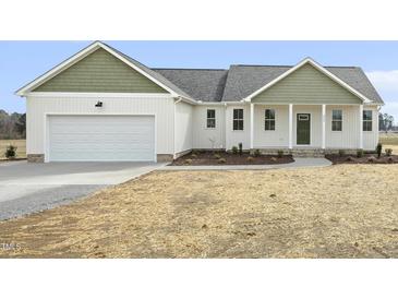 Charming single-Gathering home features an attached garage and inviting covered front porch at 239 Surles Rd, Benson, NC 27504