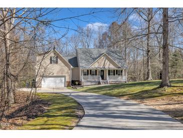 Charming two-story home features a welcoming front porch and attached two-car garage at 484 Galaxy Dr, Garner, NC 27529