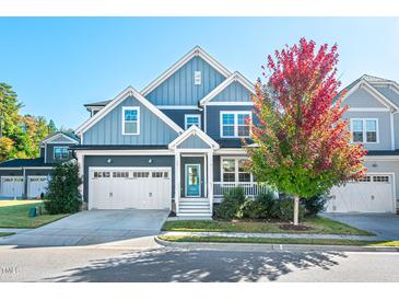 Charming two-story home with a well-manicured lawn, two-car garage, and mature tree at 52 N Rosebank Dr, Chapel Hill, NC 27516