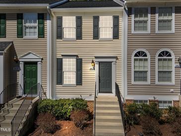 Charming townhome featuring neutral siding, dark shutters, and a welcoming front entrance with steps at 5421 Vista View Ct, Raleigh, NC 27612