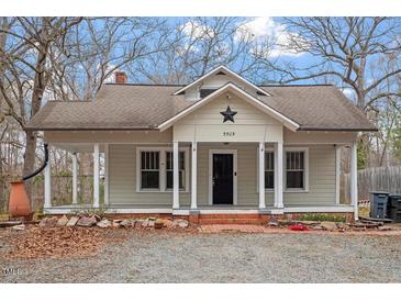 Charming single-story home featuring a cozy front porch and a well-maintained yard at 5505 Farrington Rd, Chapel Hill, NC 27517
