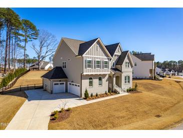 Elegant two-story home featuring a side-entry garage and beautifully landscaped front yard at 8132 Baronleigh Ln, Wake Forest, NC 27587