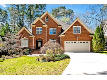 Charming brick home with a manicured front lawn and a two-car garage at 81517 Alexander, Chapel Hill, NC 27517
